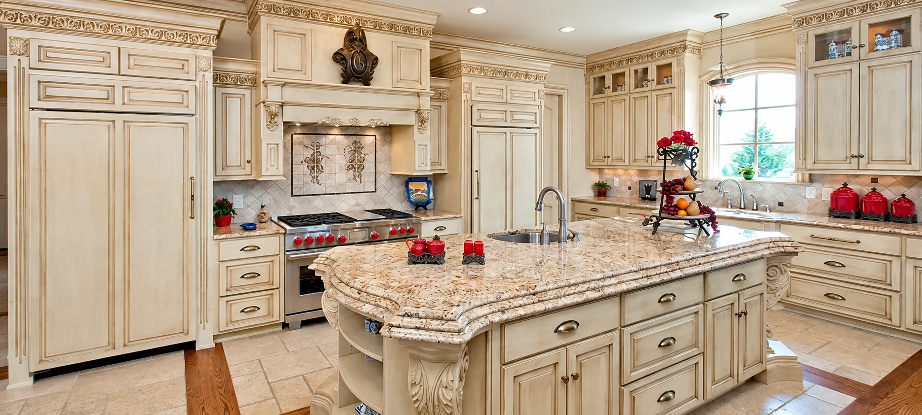 Custom cream kitchen cabinetry and central island by Black Oak Woodworks